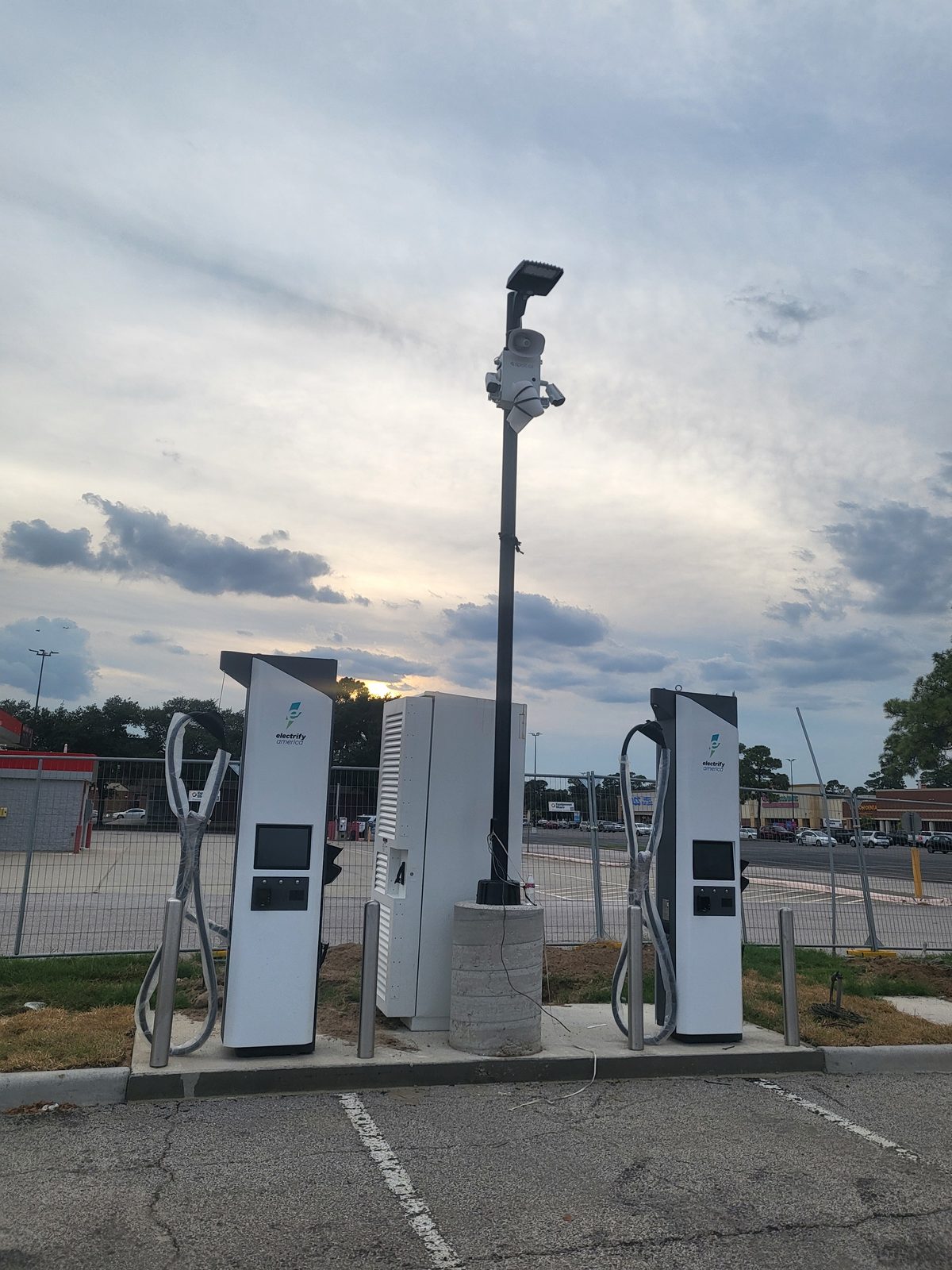 DC fast charger and transformer cabinet at dusk