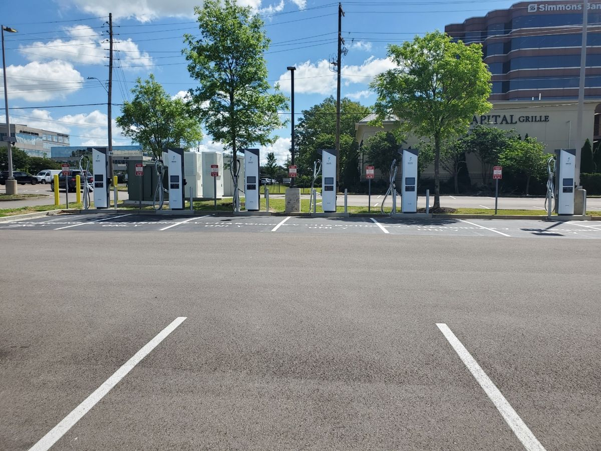 Row of DC fast chargers at a commercial lot